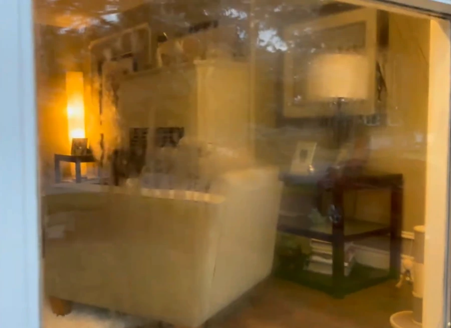 Cloudy window on a San Clemente home, salt and mineral haze dulling the glass