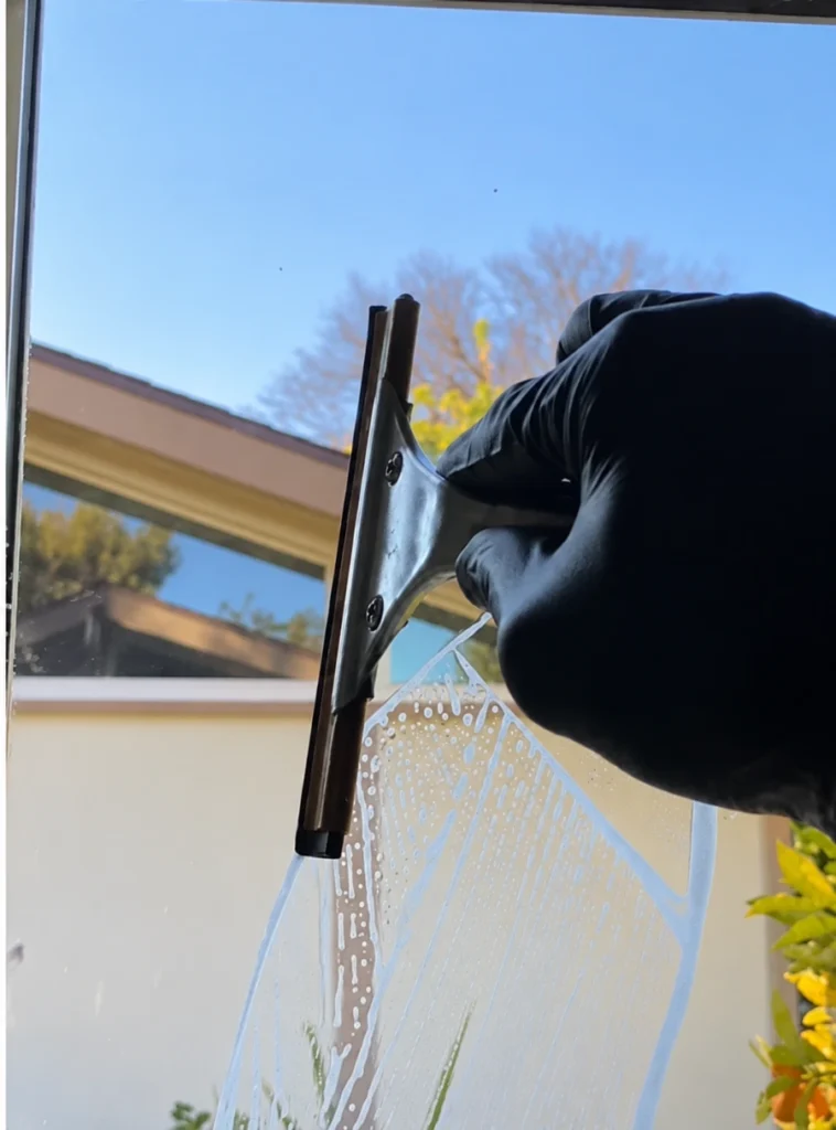 window cleaning Laguna Niguel with a squeegee during daylight