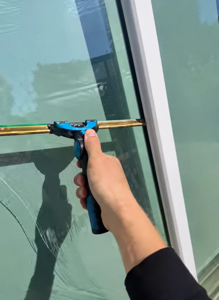 window washing in Dana Point with squeegee